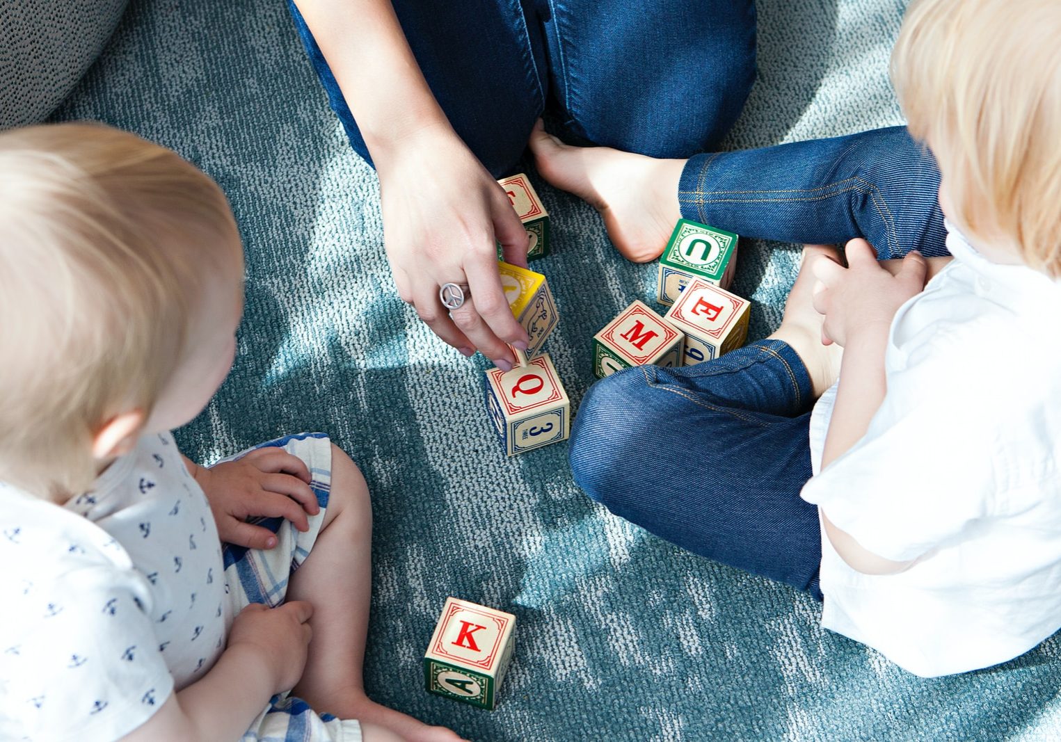 Photo by Marisa Howenstine two toddler playing letter cubes